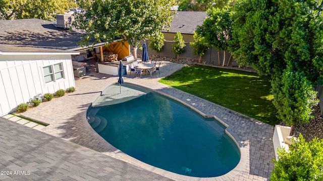 view of swimming pool featuring a patio area and a lawn