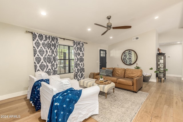 living room with vaulted ceiling, light wood-type flooring, and ceiling fan