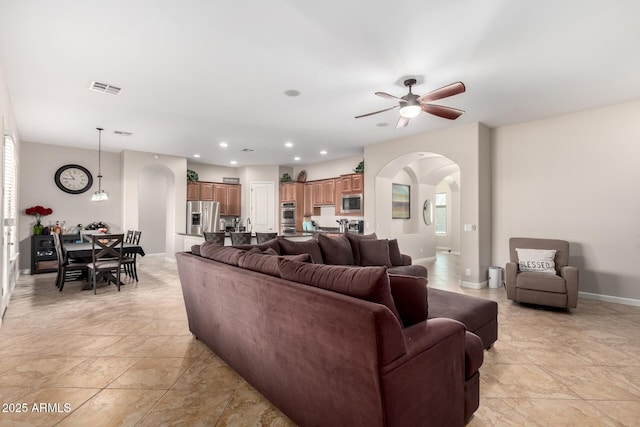 tiled living room with ceiling fan