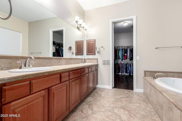 bathroom with vanity, tasteful backsplash, and tiled tub