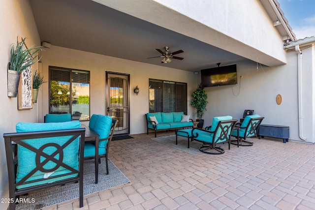 view of patio / terrace with an outdoor living space and ceiling fan