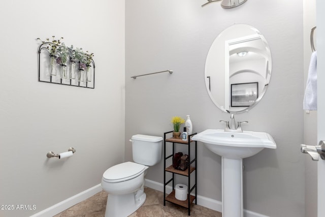 bathroom with sink, tile patterned flooring, and toilet