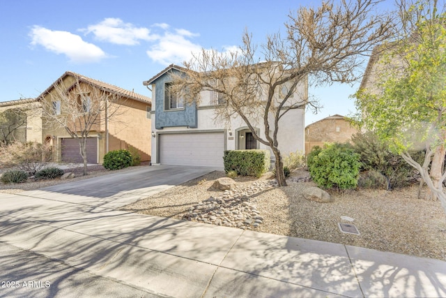 view of front of home featuring driveway, an attached garage, and stucco siding