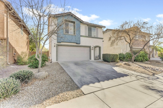 view of front of home featuring a garage, concrete driveway, a tiled roof, fence, and stucco siding