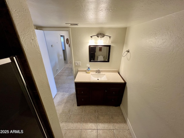 bathroom with vanity and a textured ceiling