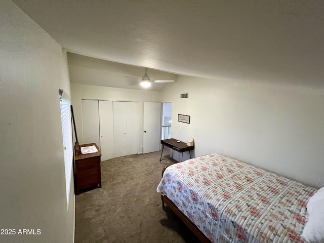 bedroom with ceiling fan, carpet flooring, vaulted ceiling, and a closet