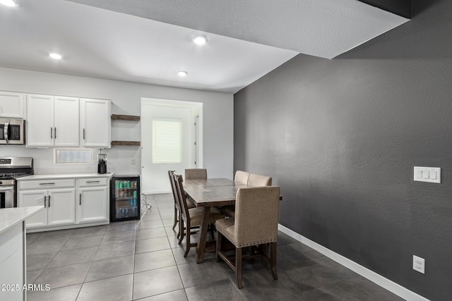 dining room featuring light tile patterned flooring and beverage cooler