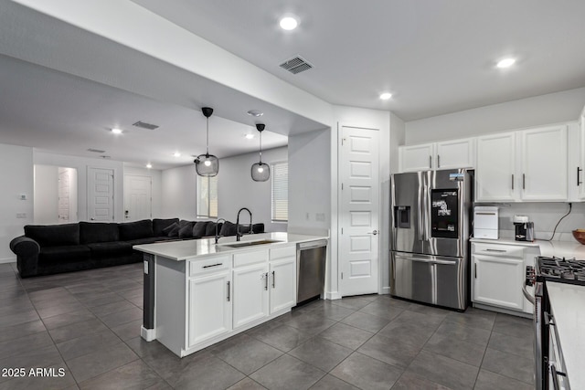 kitchen featuring white cabinetry, sink, pendant lighting, and appliances with stainless steel finishes