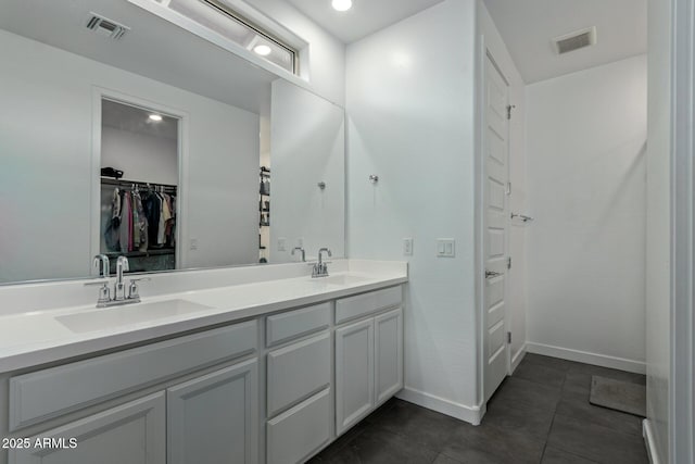 bathroom featuring tile patterned flooring and vanity