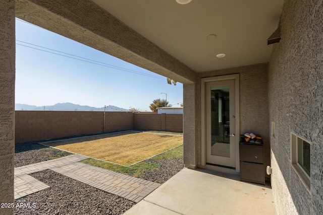 view of yard featuring a mountain view and a patio