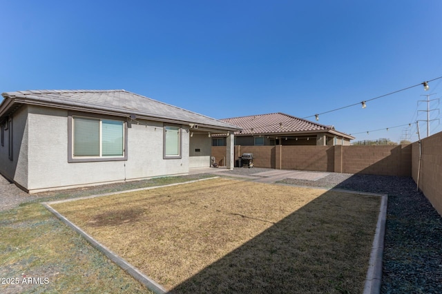 back of property with a patio