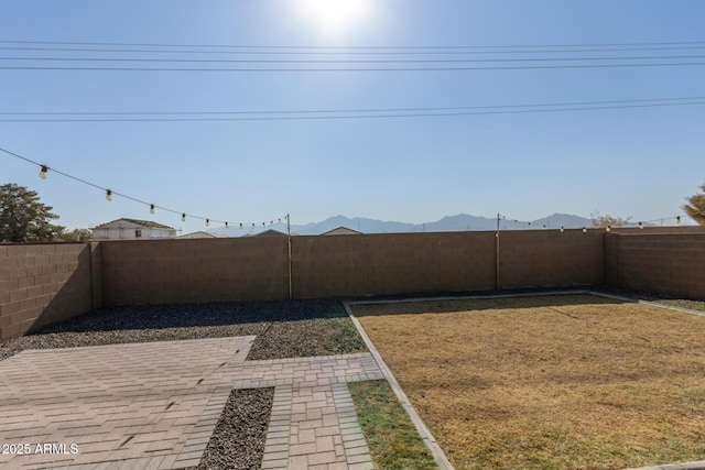 view of yard featuring a mountain view and a patio area