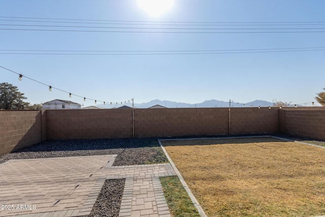 view of yard featuring a mountain view and a patio area