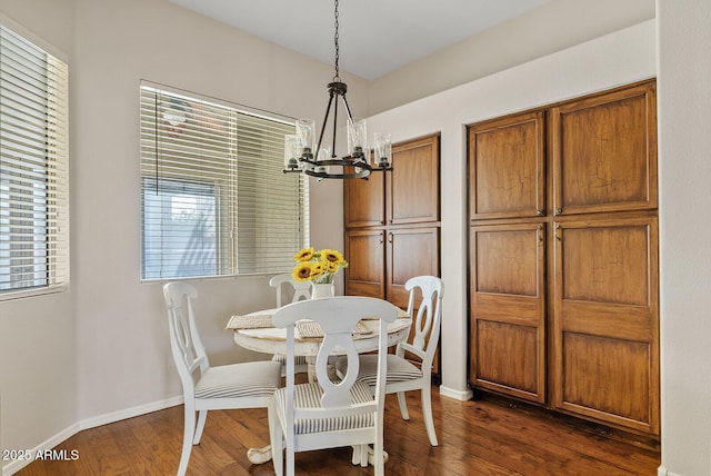 dining room featuring dark hardwood / wood-style floors and a notable chandelier