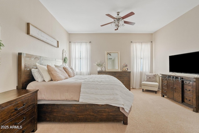 carpeted bedroom featuring multiple windows and ceiling fan