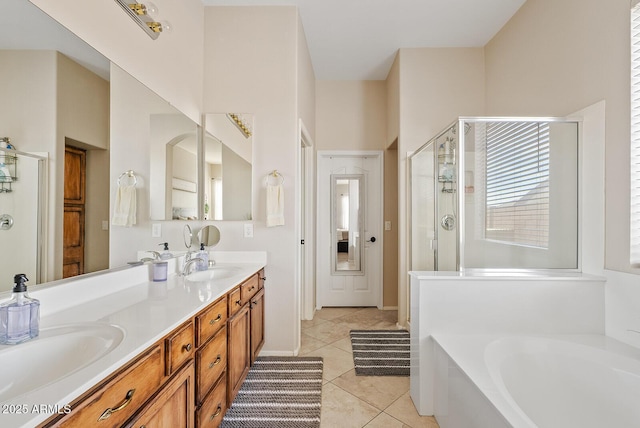 bathroom with tile patterned flooring, vanity, and separate shower and tub