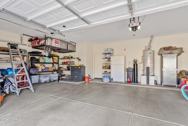 garage featuring a garage door opener, gas water heater, and white fridge