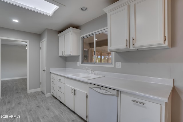 kitchen featuring a sink, white cabinets, dishwasher, and light countertops