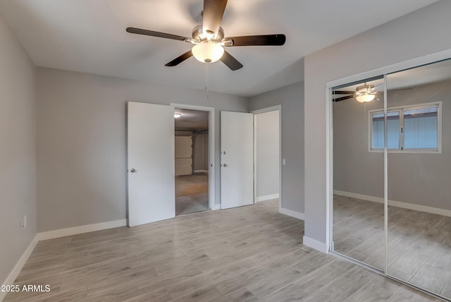 unfurnished bedroom featuring baseboards, ceiling fan, and light wood finished floors