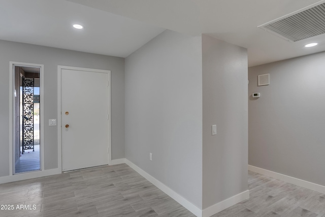 entryway featuring light wood-style floors, baseboards, and visible vents