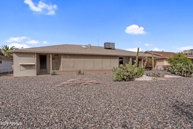 ranch-style house with fence and central AC unit