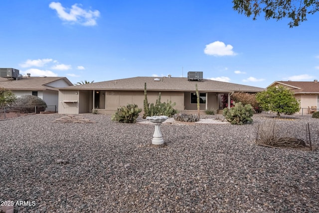 rear view of house featuring fence and cooling unit