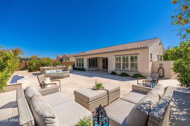 view of patio featuring outdoor lounge area and fence