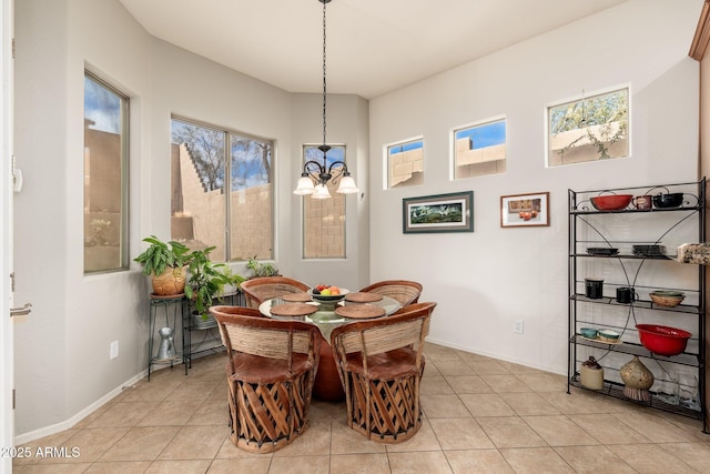 dining area featuring light tile patterned floors and a chandelier