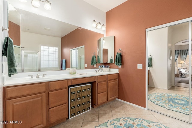 bathroom featuring tile patterned floors, an enclosed shower, and vanity