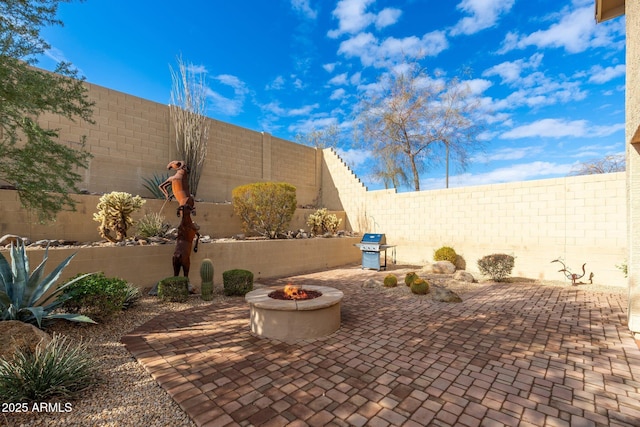 view of patio featuring a grill and a fire pit