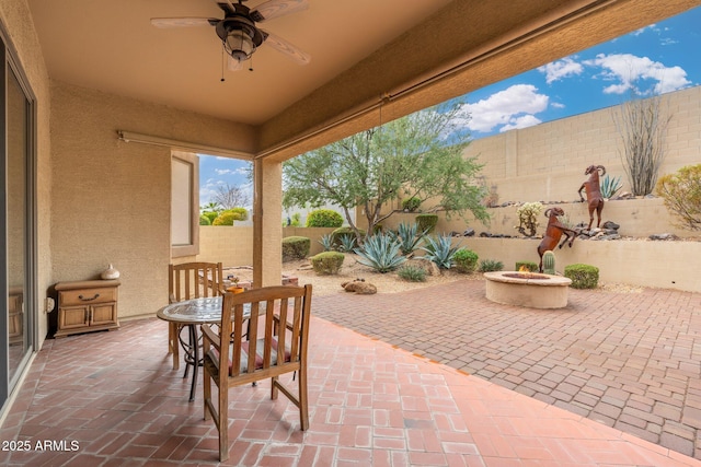 view of patio / terrace featuring ceiling fan and an outdoor fire pit