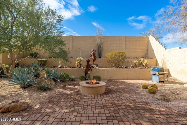 view of patio featuring area for grilling and a fire pit