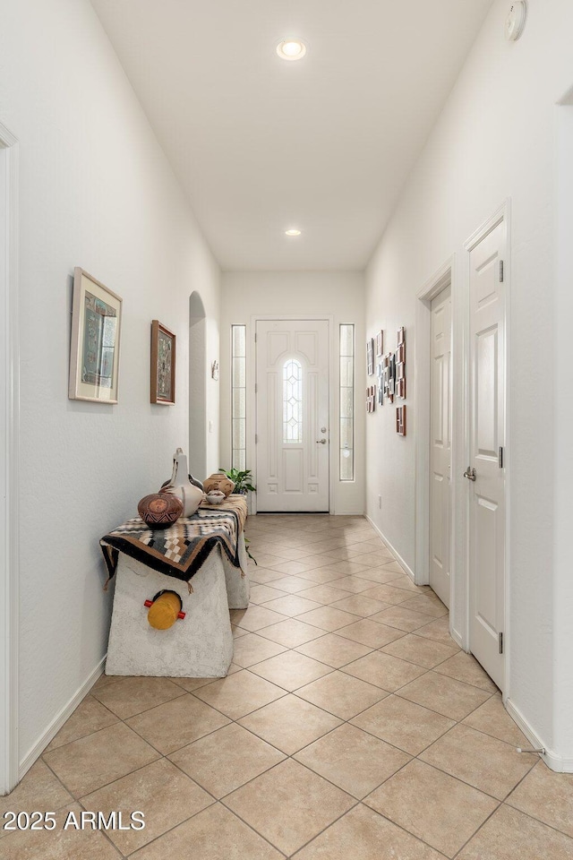 entryway with light tile patterned flooring