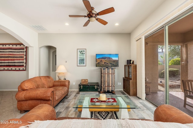 living room with ceiling fan and light hardwood / wood-style floors