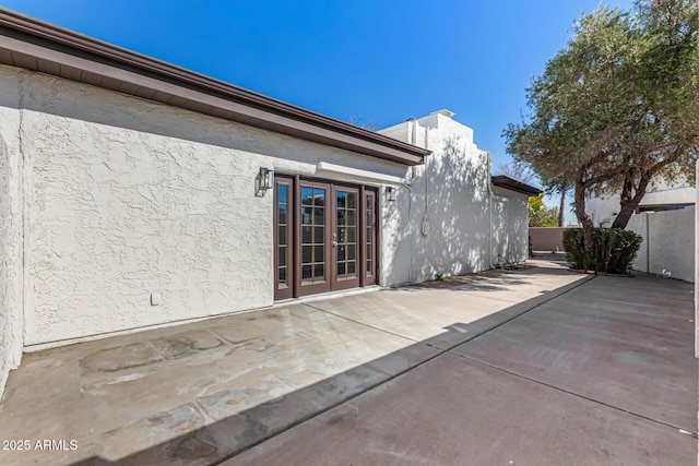 exterior space featuring a patio, french doors, and stucco siding