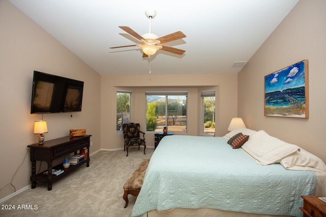 carpeted bedroom featuring lofted ceiling and ceiling fan