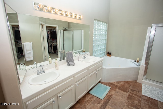 bathroom featuring vanity and separate shower and tub