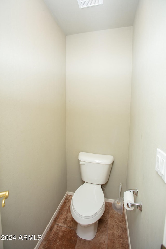 bathroom featuring toilet and tile patterned flooring