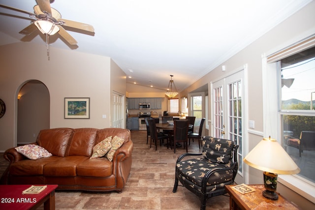 living room featuring a wealth of natural light, ceiling fan, crown molding, and lofted ceiling