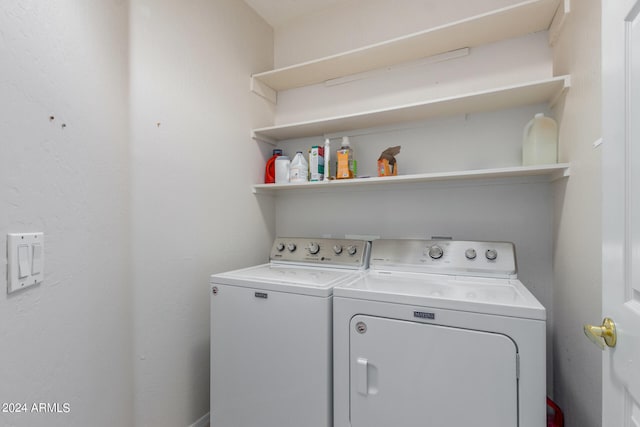 clothes washing area featuring washer and dryer