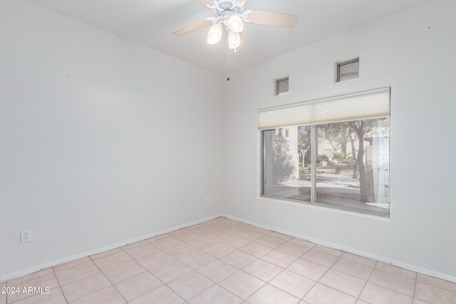 empty room featuring ceiling fan and light tile flooring