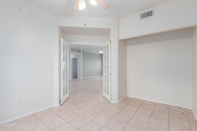 unfurnished room featuring ceiling fan, light tile floors, and french doors