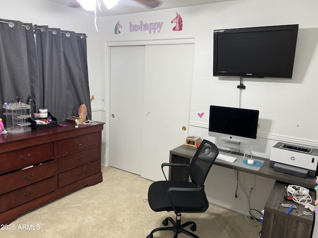 carpeted home office with ceiling fan