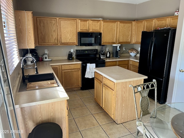 kitchen featuring a kitchen island, sink, light tile patterned floors, and black appliances