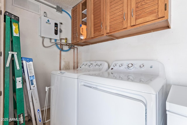 5210 W Jupiter Way N, Chandler, AZ 85226 - washroom featuring washing machine and clothes dryer, a textured ceiling, water heater, and cabinet space