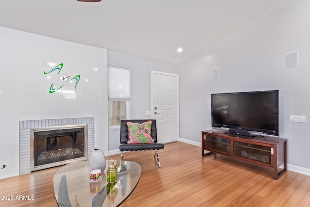 5210 W Jupiter Way N, Chandler, AZ 85226 - living area featuring wood finished floors, vaulted ceiling, recessed lighting, and a fireplace