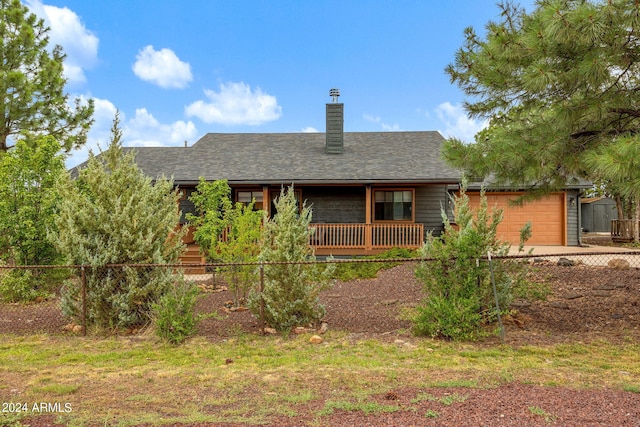 rear view of house featuring covered porch