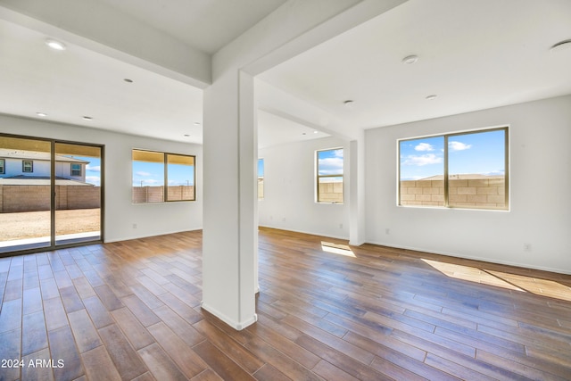 unfurnished living room featuring baseboards, dark wood-style flooring, and recessed lighting