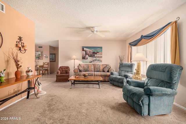 carpeted living room featuring a textured ceiling and ceiling fan