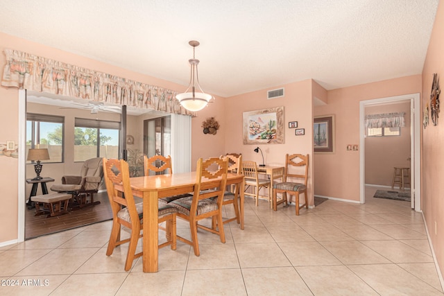 tiled dining area featuring ceiling fan